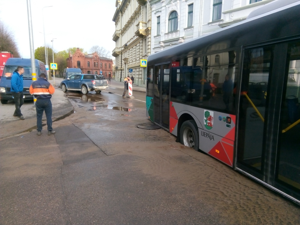 (papildināta) FOTO: Liepājā autobuss iekrīt asfalta akacī